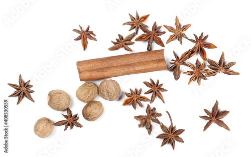 Cinnamon stick with anise stars and nutmeg pile isolated on white background  top view