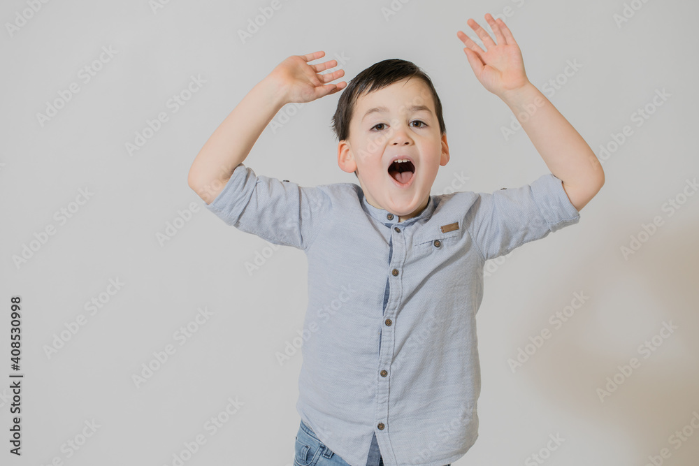child screaming.5 year old boy stretches his arms up. Child is very excited. Child is having fun. Expression of wonder child screaming.5 year old boy stretches his arms up. Child is very excited. Child is having fun. Expression of wonder