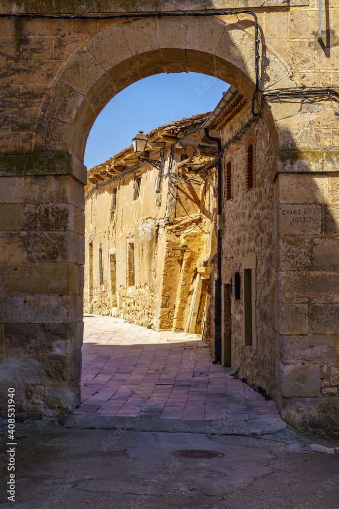 Medieval village with stone houses, cobblestone streets, old doors and windows, arches and walls. Maderuelo Segovia Spain.
