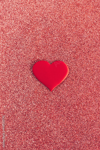 Red heart on a red sparkle background. Minimal concept for Valentine day.