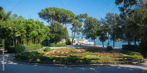 spa garden Opatija, Croatia with bamboo, buxus and begonia flower beds and walkway