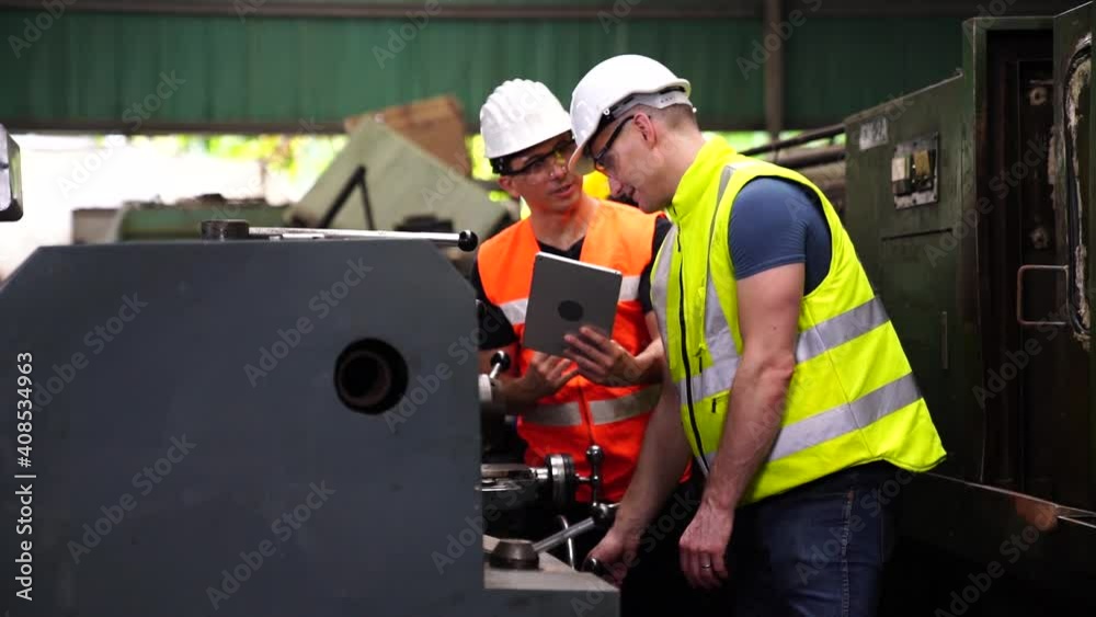 Worker in manufacturing plant at Machine control panel. Milling machine operator working in factory workshop.