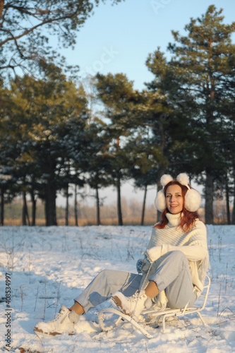 Smiling woman has fun with snow outdoors