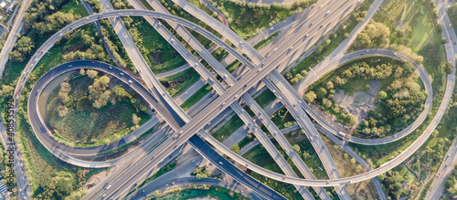 Foto Aerial view of road interchange or highway intersection with busy urban traffic speeding on the road