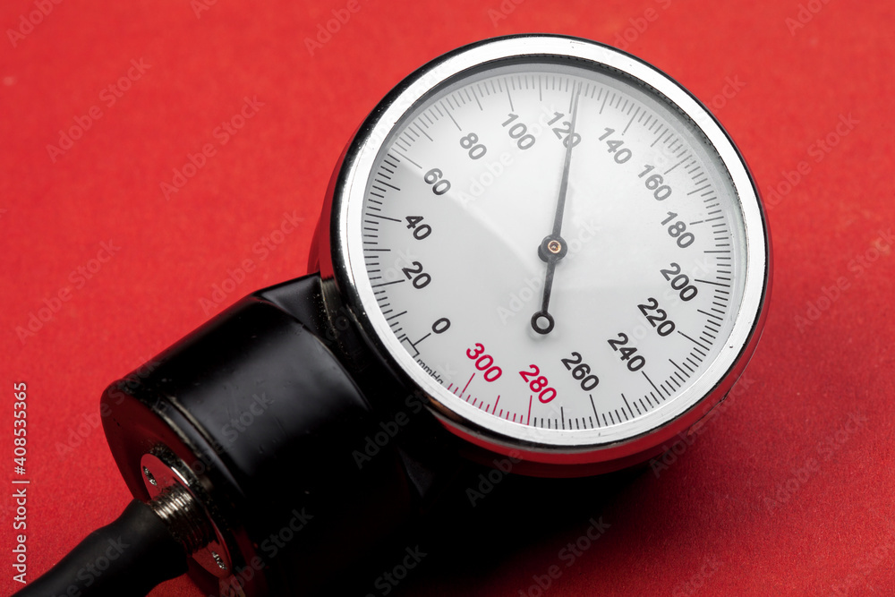 KIEV, UKRAINE - January 26, 2021: Microlife blood pressure device on red background. Arrow 120 KIEV, UKRAINE - January 26, 2021: Microlife blood pressure device on red background. Arrow 120
