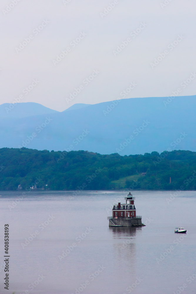 house on the hudson river with boat and mountains landscape