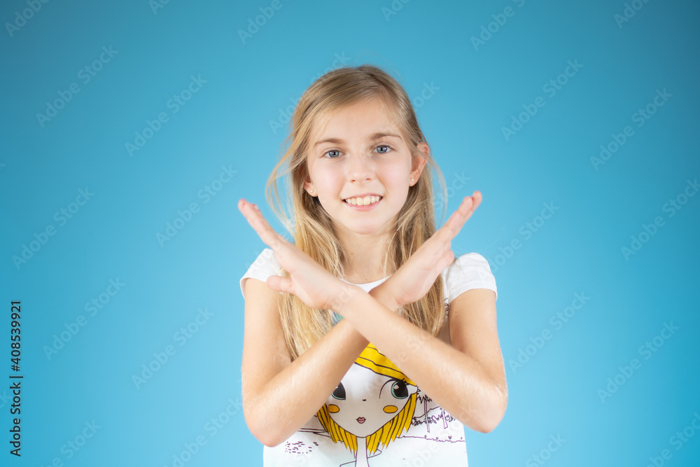 Little girl over white background doing stop sing with arms crossed. Warning expression with negative and serious gesture on the face. Little girl over white background doing stop sing with arms crossed. Warning expression with negative and serious gesture on the face.