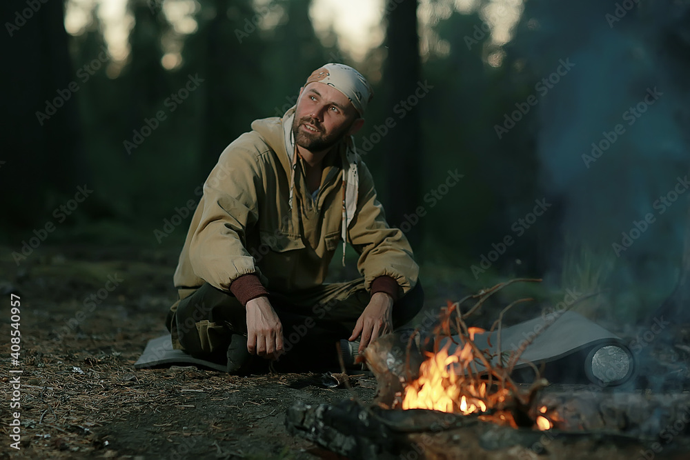 tourist bonfire huntsman, a man in the taiga basking in the fire tourist bonfire huntsman, a man in the taiga basking in the fire