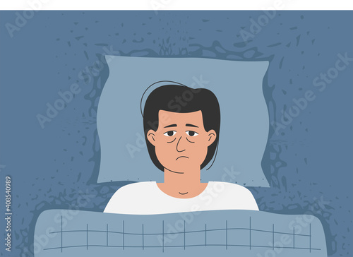 A man with wide eyes is lying in bed, he can't sleep. The problem with anxiety and insomnia.