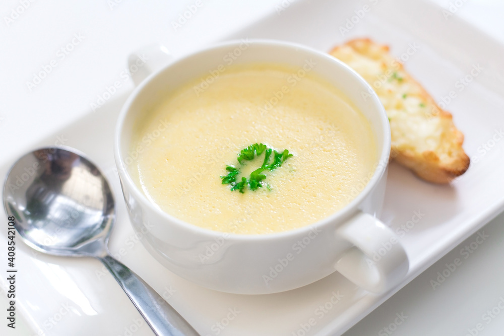 Delicious corn soup In a white bowl served with bread. Delicious corn soup In a white bowl served with bread.