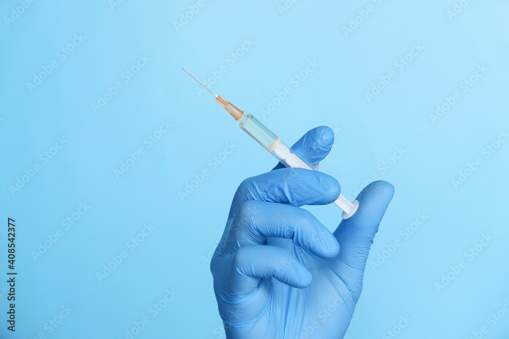 doctor hand in medical gloves holding syringe. doctor hand in medical gloves holding syringe.