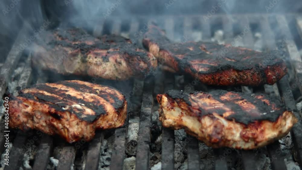 meat steak fried on a wire rack with smoke and fire meat steak fried on a wire rack with smoke and fire
