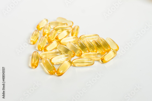 Heart of cod oil capsules isolated on white background. Valentines day and healthy heart concept.
