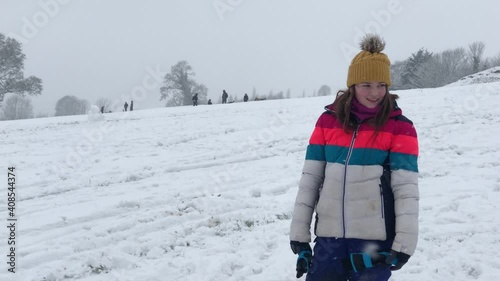 People sledging down a hill on a snowy day in late January 2021