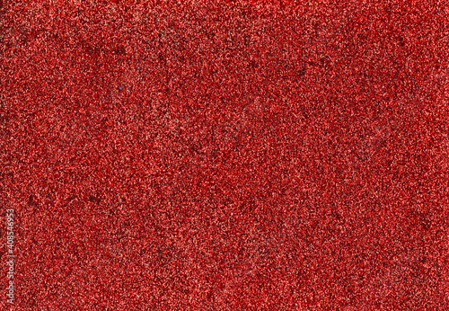 Red glitter texture abstract background. Shiny glowing colors. Concept of holidays, invitation, christmas or party.