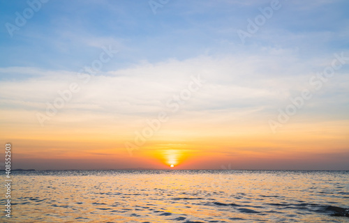 Sunset sky over sea in the evening with colorful orange sunlight sky landscape background.