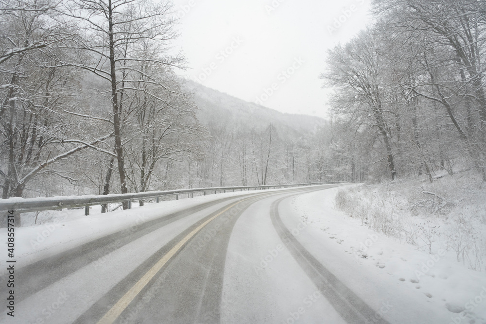 Winter road, during snowfall near Bakonybel, a small touristic town located in the Bakony mountain range in Hungary.