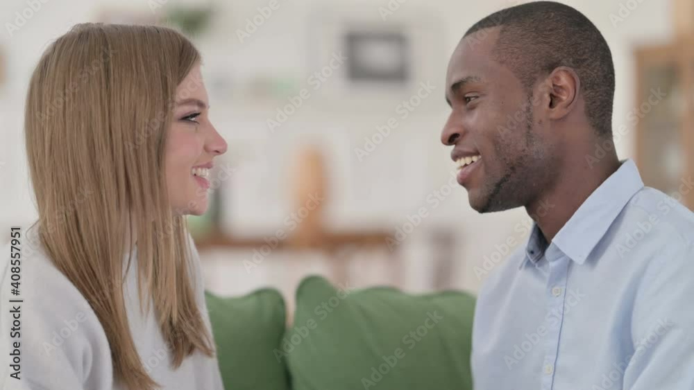 Happy Mixed Race Couple Smiling at Each other Lovingly at Home Happy Mixed Race Couple Smiling at Each other Lovingly at Home