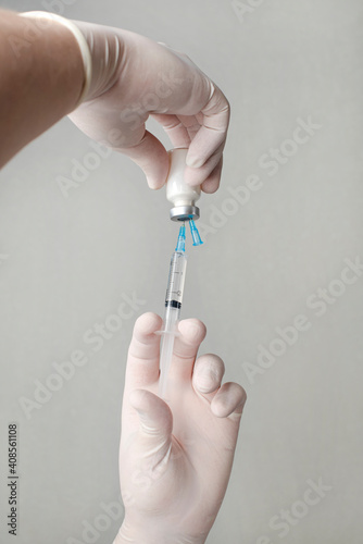 Concept fight against virus covid-19 corona virus, doctor holding a syringe with liquid vaccines. Concept:diseases,medical care,science.