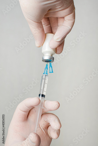 Concept fight against virus covid-19 corona virus, doctor holding a syringe with liquid vaccines. Concept:diseases,medical care,science.