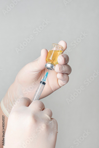 Concept fight against virus covid-19 corona virus, doctor holding a syringe with liquid vaccines. Concept:diseases,medical care,science.