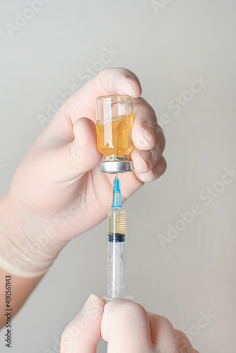 Concept fight against virus covid-19 corona virus, doctor holding a syringe with liquid vaccines. Concept:diseases,medical care,science.