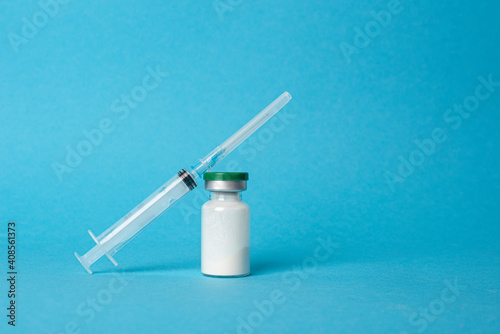 Vaccine and syringe injection on blue background . Preventive,immunization and treatment from corona virus infection. Medicine infectious concept. Copy space
