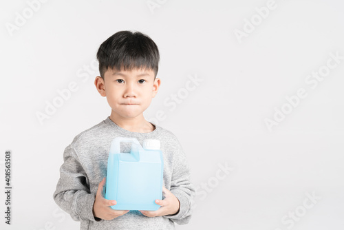 Asian boy holding 1000 cc, a liter plastic bottle