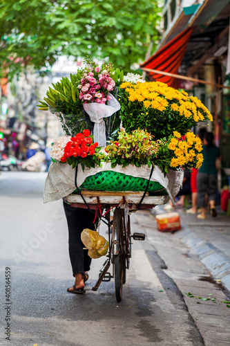 Hanoi, Vietnam - june 12, 2019: Old quarter of hanoi. Street sellers sell fruit from their bikes in traditional hats
