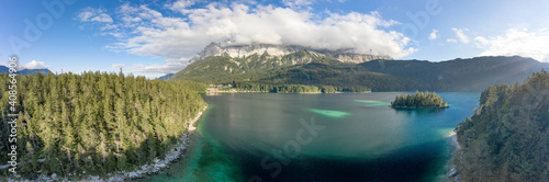 Panoramic aerial view of Zugspitze mountain heavy fog by Eibsee Lake in Germany