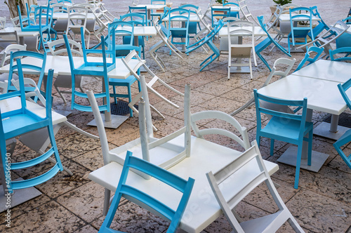 View of some restaurant chairs in the touristic marina of Lipari, island of the archipelago of the Aeolian Islands, during summer afternoon. 