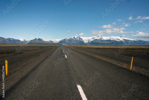 A road through a rural landscape in near Olavsvik, Iceland.
