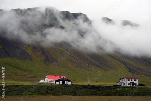 Houses in a rural landscape in near Olavsvik, Iceland.