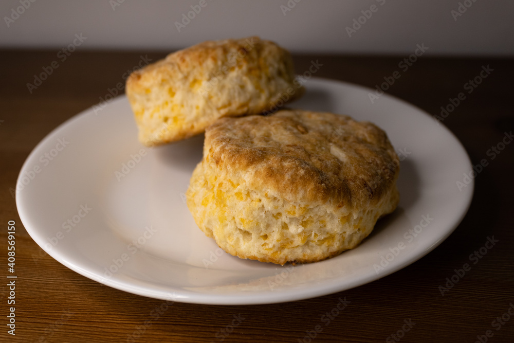 two cheese tea biscuits on a white plate.