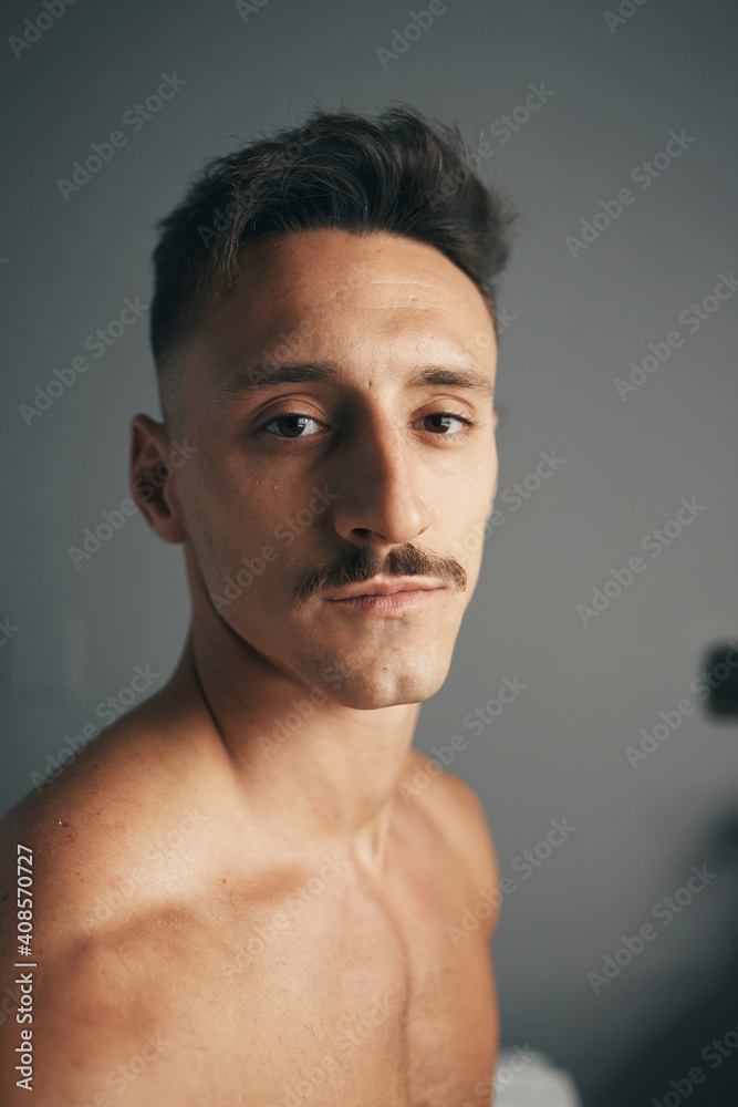 Portrait of a young boy with a moustacheon a grey background Portrait of a young boy with a moustacheon a grey background