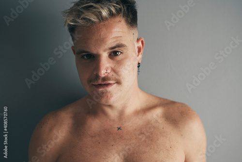 Portrait of a blond boy with a moustache and piercing