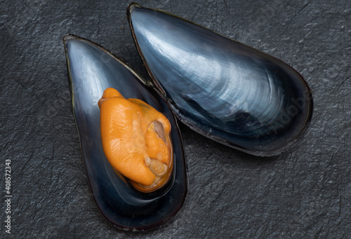 steamed mussels from galicia on black background