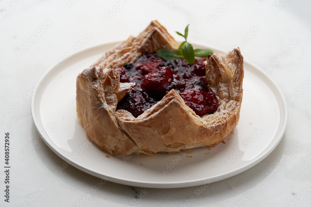 Puff pastry cake with berries on wooden background. Puff pastry cake with berries on wooden background.