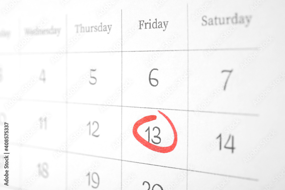Calendar page with marked Friday 13, closeup. Bad luck superstition Calendar page with marked Friday 13, closeup. Bad luck superstition