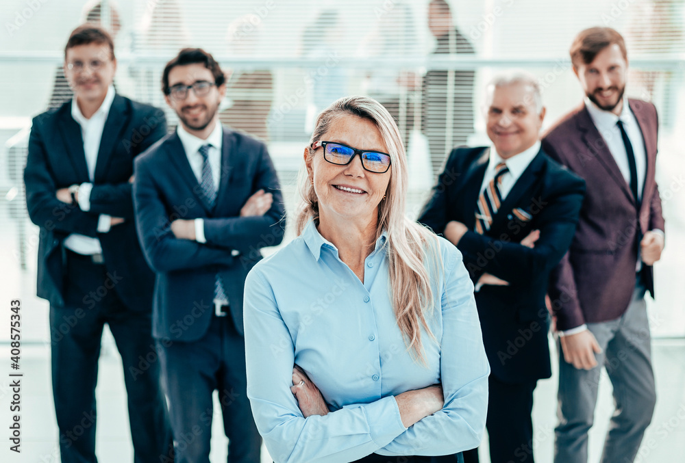 proud business woman standing in front of a business team proud business woman standing in front of a business team