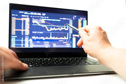 Hombre estudiando finanzas criptomonedas en un ordenador con un lapiz en la mano sobre fondo blanco photo