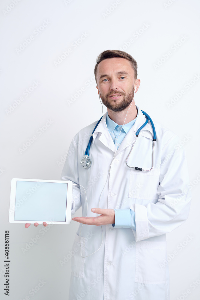 Young male doctor in whitecoat and earphones making presentation of new vaccine Young male doctor in whitecoat and earphones making presentation of new vaccine
