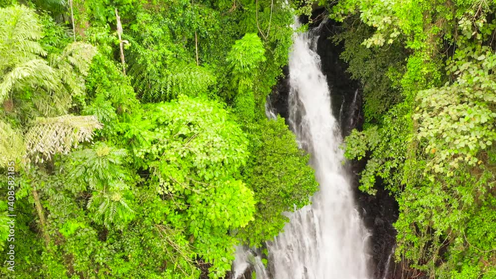 Waterfall in the rainforest view from above from above. Tropical Tinago Falls in mountain jungle. Philippines, Mindanao. Iligan City, Lanao del Norte. Waterfall in the rainforest view from above from above. Tropical Tinago Falls in mountain jungle. Philippines, Mindanao. Iligan City, Lanao del Norte.