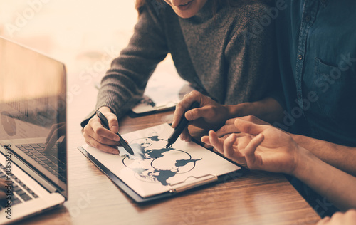 Elements of this image furnished by NASA. smiling colleagues discussing the logistics of the scheme.