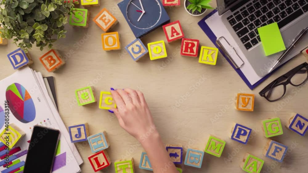Woman hand arranging wooden cubes with word ECONOMY top view Woman hand arranging wooden cubes with word ECONOMY top view