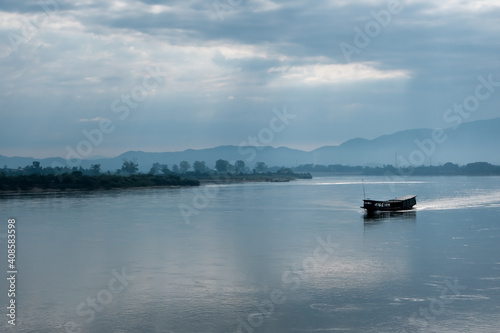 Cargo ships sailed in the middle of the Mekong River.