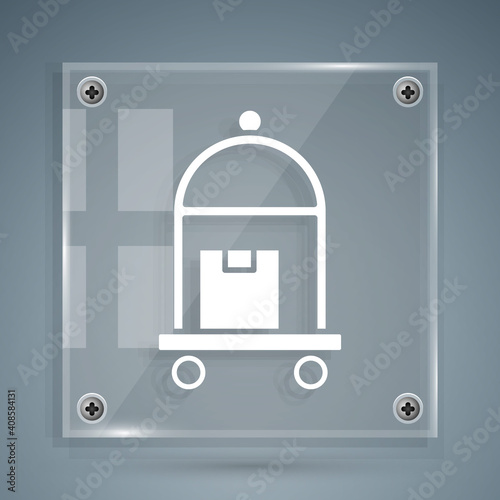 White Hotel luggage cart with suitcase icon isolated on grey background. Traveling baggage sign. Travel luggage icon. Square glass panels. Vector.