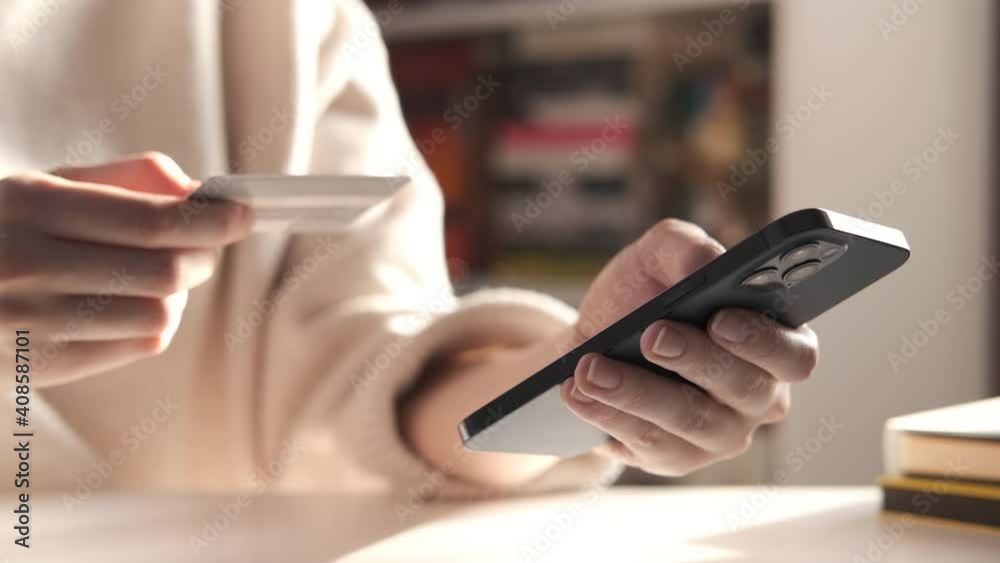 Female hand holding credit card and shopping online. Easy pay using digital gadget. Girl using laptop at home. Happy woman with compact computer and bank card shopping online. Lifestyle 4K