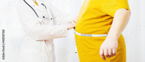 doctor measures man measures waist