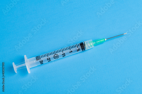 Hygienic Single-Use Disposable Syringe Injection On Blue Background